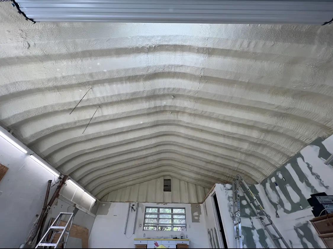 Spray polyurethane foam applied to the underside of a metal roof deck in Sturtevant